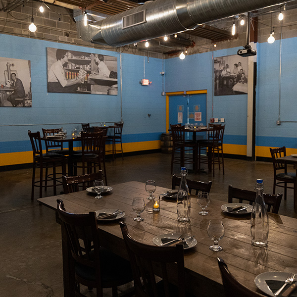 multiple tables set in the bomb shelter, sloop's private events space